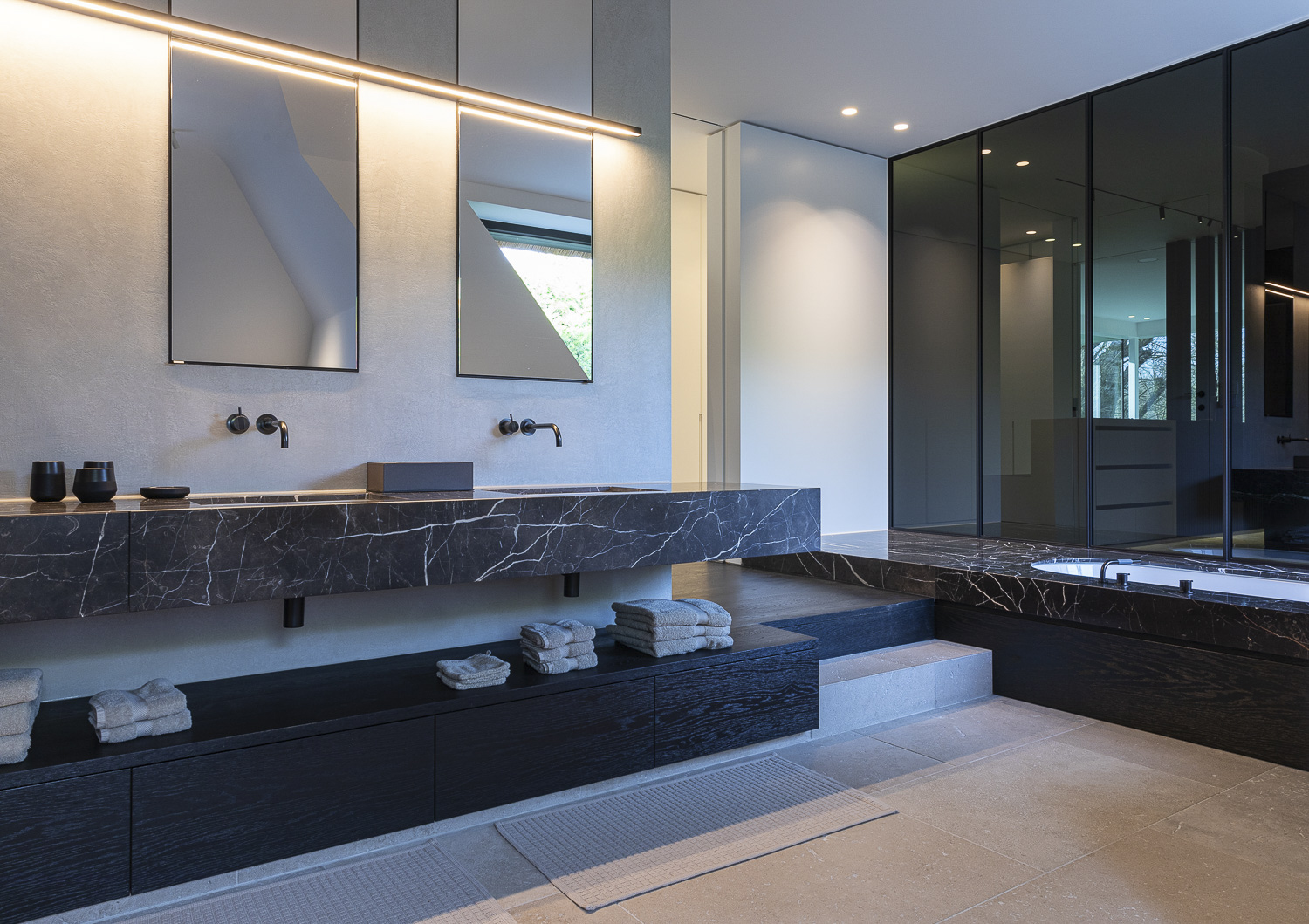 A luxurious bathroom with a marble sink and a mirror.