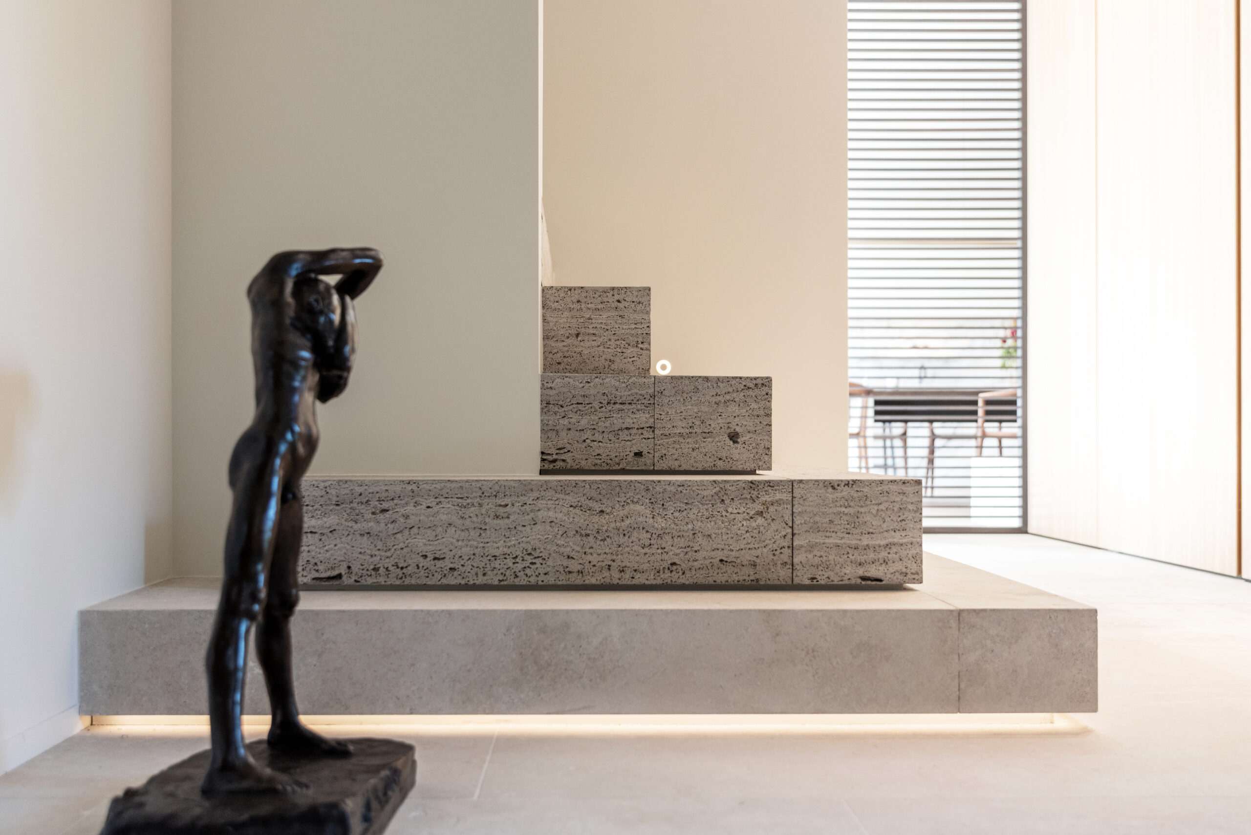 Bronze sculpture in a modern, minimalist interior.